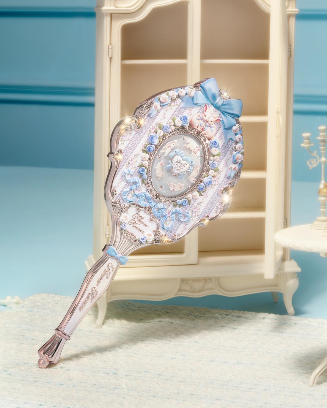 Bunny Garden Hand Mirror with blue style held in hand 